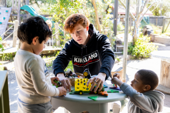 Young man teaching toddlers