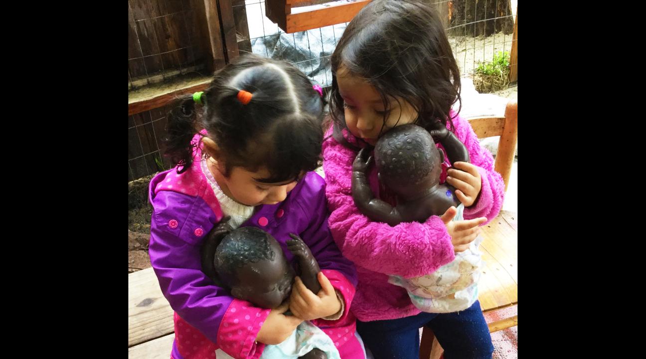 Girls hugging their baby dolls